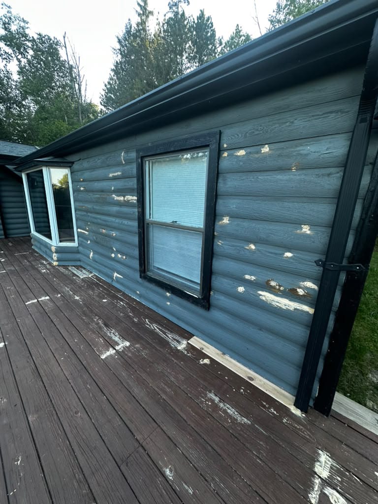 Before deck painting New York project showing a faded and weathered outdoor deck